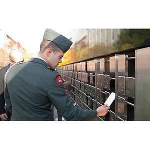 A man in uniform looks at the plaques on the Veterans Memorial at the dedication ceremony