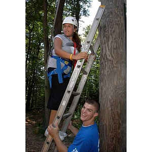 Joseph Bordieri holds the ladder for Nadia Alvarez at the Torch Scholars Project Adventure Ropes Course