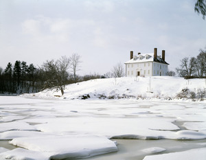 Exterior from across the river in snow, Hamilton House, South Berwick, Maine