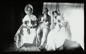 Group portrait of Elinor Curtis and two unidentified people, seated on chairs, facing front, dressed in costumes, location unknown, undated