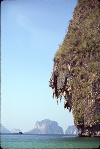 Offshore karst outcroppings and boat in the distance, Princess Cove, Phra Nang Bay, Southern Thailand