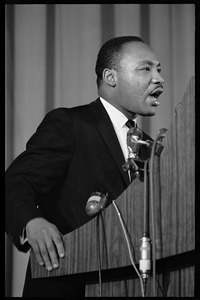 Martin Luther King, Jr., speaking from a podium