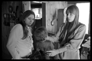 Joni Mitchell (right) and Judy Collins, playing with a Graham Nash doll at Mitchell's house in Laurel Canyon