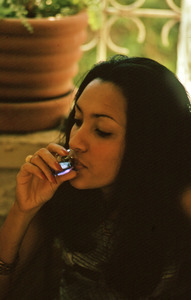 Young Hatian woman drinking liqueur