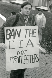 Protester holding a sign reading 'Ban the CIA not protesters': in front of Whitmore Building, UMass Amherst