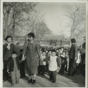 Shirley Graham Du Bois holding hands with two unidentified children