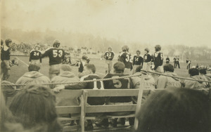 Football players waiting on the sidelines