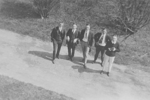 Class of 1921 members pose on a road