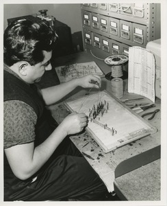 A man does an electronics assembly job at TOWER training