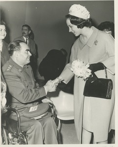 Princess Benedikte of Denmark shaking hands with a disabled veteran during her tour of an ICD facility