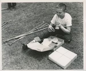 Boy with crutches eating lunch