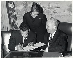 Eliyahu Nawi, Mayor of Beersheba, Israel, signing the guestbook with his wife and Mayor John F. Collins.