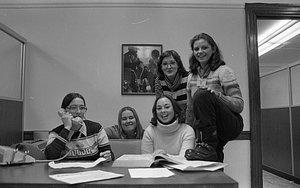 Unidentified women posing at office desk