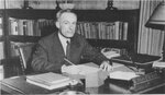 Suffolk University Dean Lester R. Ott, Lester (CAS 1945-1949), seated behind desk, photograph, circa 1940s