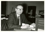 Suffolk University Professor Benson Diamond (CAS) sitting at his desk, photograph, circa 1950s