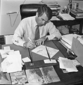 Sheet of photographs of Paul E. Tsongas at a desk