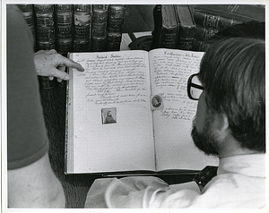 [Unidentified man looking at records]