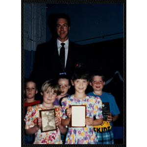 Former Boston Celtic Dave Cowens posing for a group picture with five boys and girls at a Kiwanis Awards Night