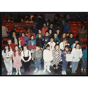 Award recipients standing in lines for a group picture at a Boys and Girls Club event