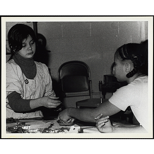Two girls working on projects for their arts and crafts class at the Boys' Clubs of Boston