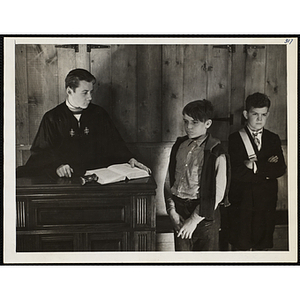 Three boys strike a dramatic pose in a mock court