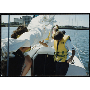 Children unpack rigging on a sailboat in Boston Harbor