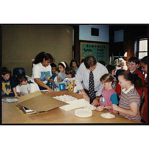 Charlestown Director Jerry Steimel serves cake to children