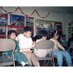 Children play musical chairs at a Chinese Progressive Association event