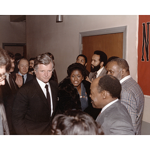 Senator Edward Kennedy walks through a crowd while visiting Northeastern University