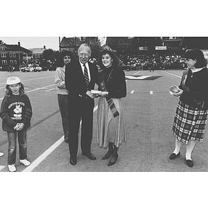 President Ryder congratulates Homecoming Queen Bobi Walker on the football field