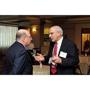 Dean Larry Finkelstein speaking with Chairman Sy Sternberg