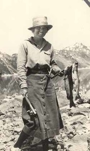 Eleanor "Nora" Saltonstall in mountains holding fish