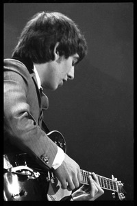 George Harrison playing guitar in concert with the Beatles, Washington Coliseum