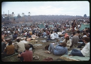 Concert goers lying on blankets and in tents, watching the stage, Woodstock Festival