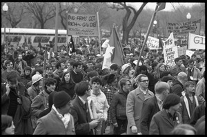 Crowd of marchers in the streets at the Counter-inaugural demonstrations, 1969, with banners 'Big firms get rich -- GIs die'