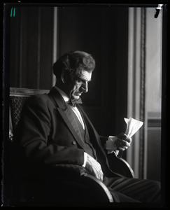 Lincoln Caswell, Abraham Lincoln impersonator, seated and reading