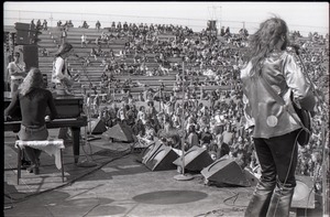 Hollywood Speedway Rock Festival: Jo Jo Gunne in performance, view (l. to r.) from rear of guitarist (Matt Andes), keyboards (Jay Ferguson), and bassist (Jimmy Randall)