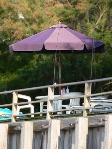 Picnick table and umbrella on a wooden deck