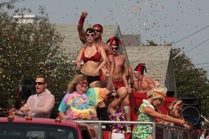 Bruce Vilanch and dancers on top of a float, throwing confetti : Provincetown Carnival parade