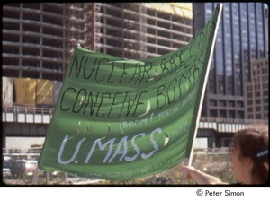 MUSE concert and rally: demonstrator holding a 'U.Mass PIRG' banner