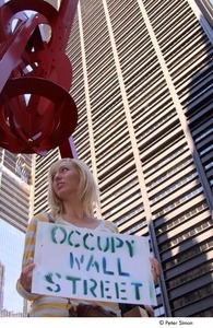 Occupy Wall Street: woman holding stenciled sign reading, 'Occupy Wall Street'