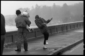 Judy Salonia, her husband Vincent, and daughter Ashley (4) dodge the spray at the Narragansett seawall