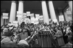 Gary Hart at a microphone-encrusted podium, addressing an crowd after renewing his bid for the Democratic nomination for the presidency
