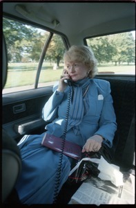 Margaret Heckler, United States Ambassador to Ireland, taking a phone call in the back of a limousine