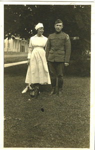 Lawrence D. Yeomans, in uniform, standing with unidentified nurse and bulldog