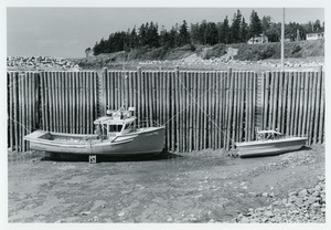 Two boats stranded at low tide