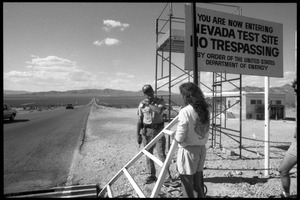 Peace encampment activists talking a security guard at the entrance to the Nevada Test Site