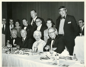 Robert C. Wood with group of people at banquet