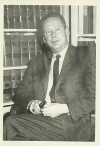 Fred Virgil Cahill, sitting indoors