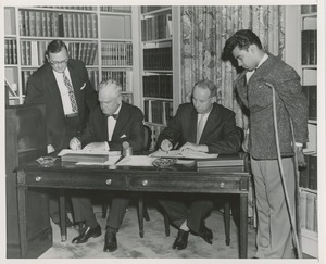 Presidents Bruce Barton of ICD and Carroll V. Newsom of NYU being presented with pens with which to sign an affiliation agreement